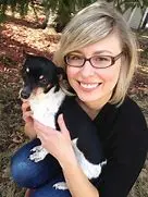 Cori Doerrfeld smiling woman holding a cute dog