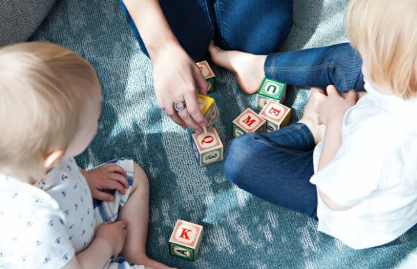 woman and child playing game blocks