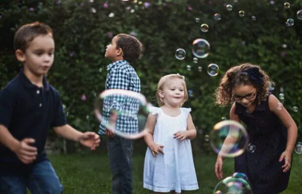 toddler preschooler kids group playing with bubbles