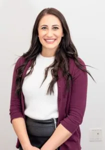 smiling woman wearing white shirt velvet cardigan